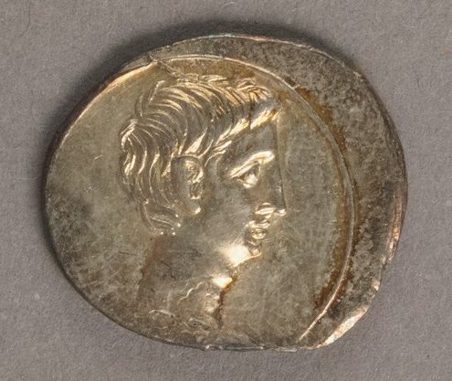 Silver denarius of Octavian, later Augustus, showing a bare-headed profile on one side and a standing figure on the other.